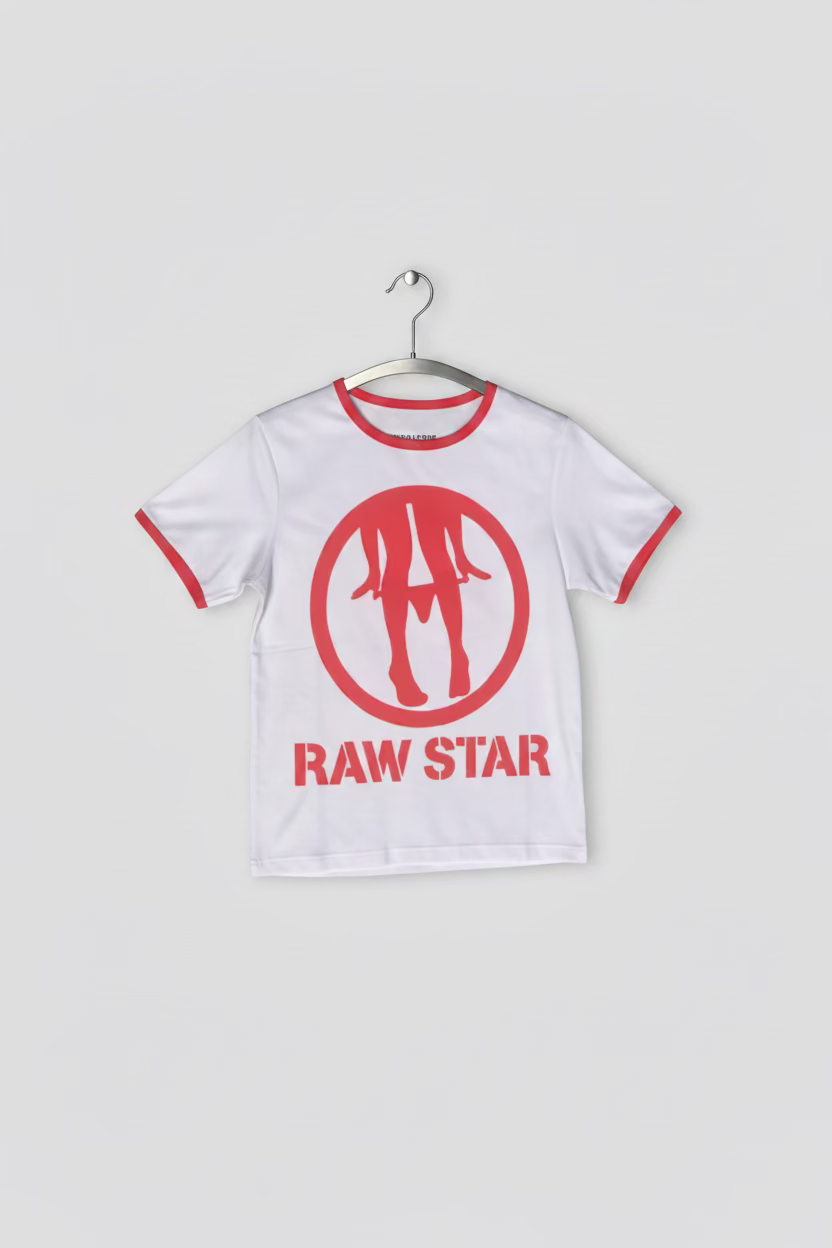 A white short-sleeve t-shirt with red trim on the collar and sleeve cuffs, featuring a red circular logo with three stylized figures and the text 'RAW STAR' printed vertically on the front. The shirt is laid flat on green grass.